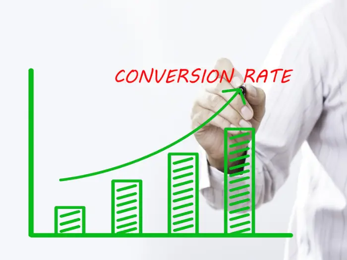 "CONVERSION RATE" text with hand of young businessman point on virtual graph green line and bar showing on increasing with background -business, finance, salary, crisis, and development concept