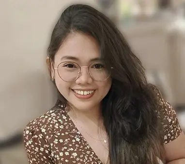 woman with glasses smiling in an office