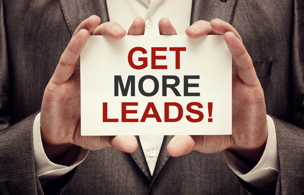 Businessman holding a sign that says "Get More Leads" in bold letters