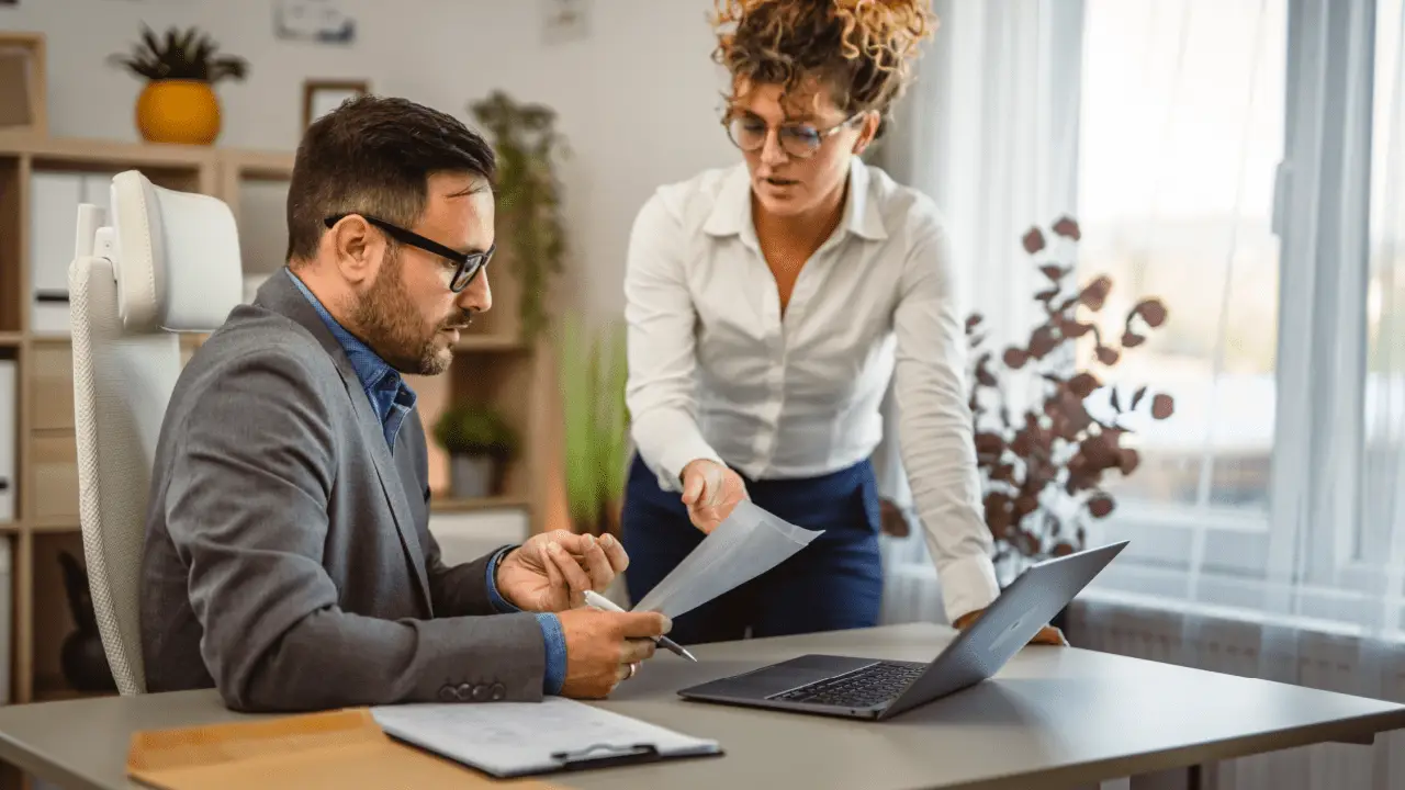 Legal professionals reviewing bankruptcy legal leads and case documents in bright modern office