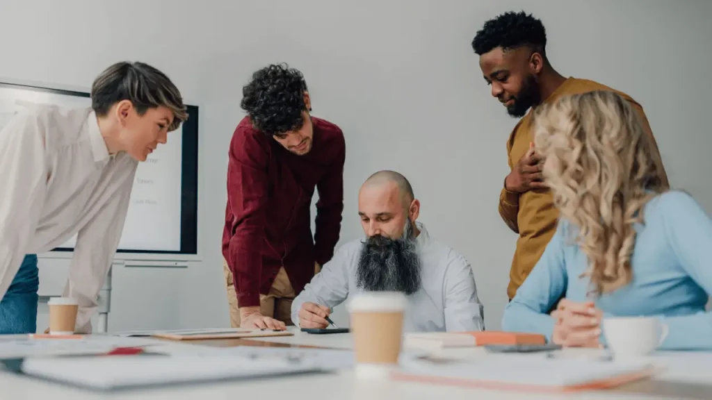 Team collaborating on how to market a law firm during a strategy meeting around a conference table