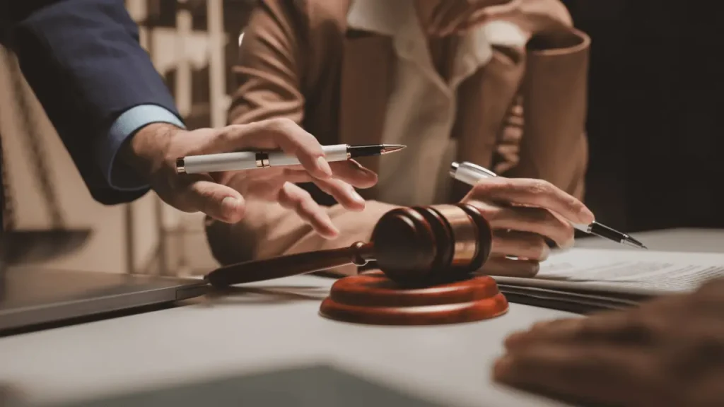 Two attorneys reviewing legal documents at a desk with a gavel, discussing lead generation approaches for attorneys