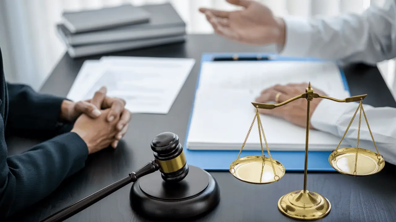 Two attorneys discussing a legal marketing strategy for small firms at a desk with a gavel and scales of justice
