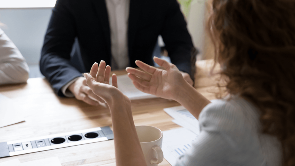 Attorney meeting with client across desk in professional consultation
