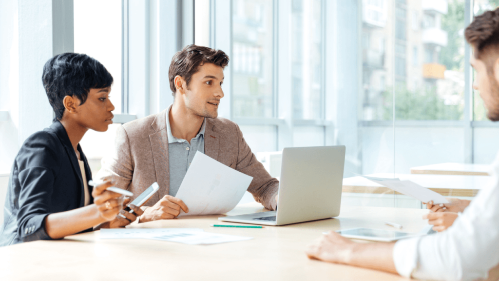 Exclusive Legal Leads - Legal team meeting with client across conference table with documents and laptop