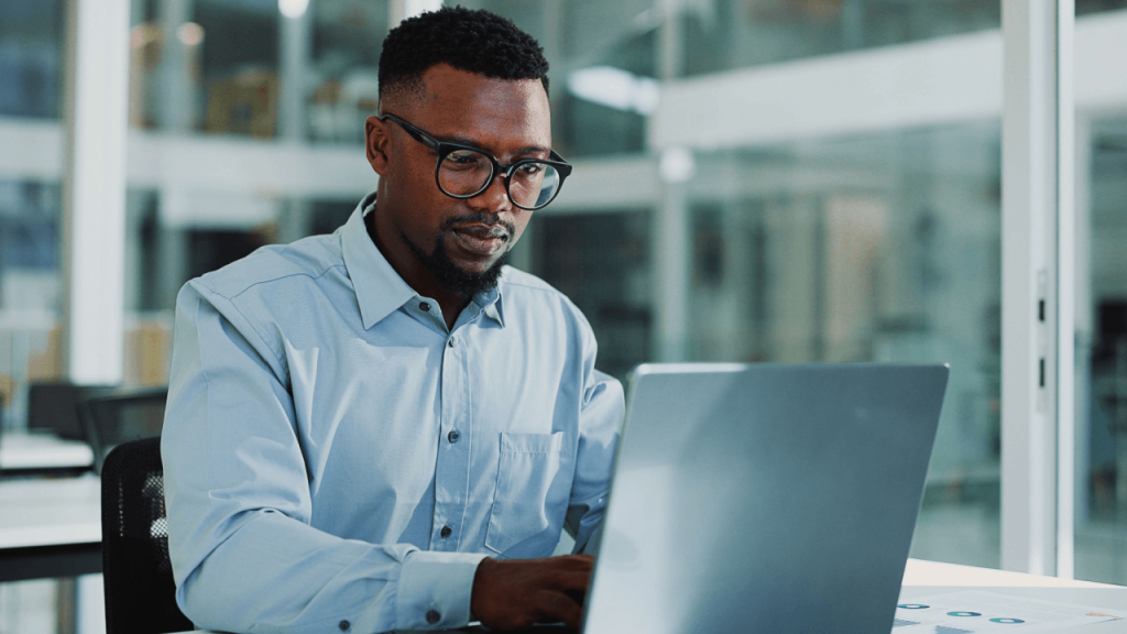 Personal injury attorney reviewing lead cost data on laptop in modern law office