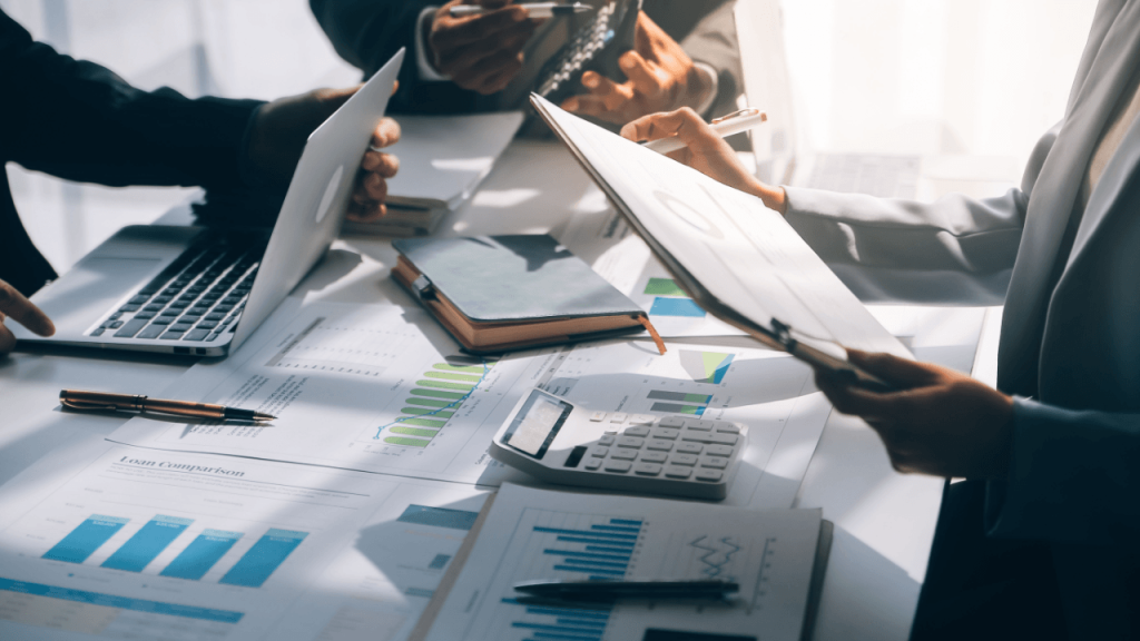 Law firm lead sources strategy meeting with attorneys reviewing marketing data and charts