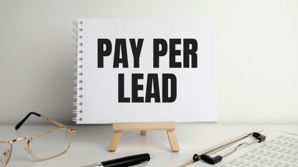 Pay Per Lead for Lawyers – notebook displaying "Pay Per Lead" text on a mini easel with glasses, pen, and financial documents on a desk